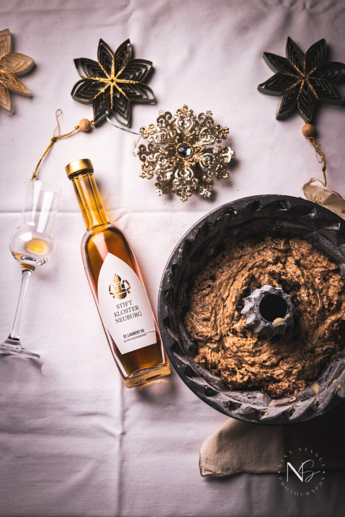 Overhead shot of a holiday spice cake with golden candied oranges, ready to serve as a festive dessert.